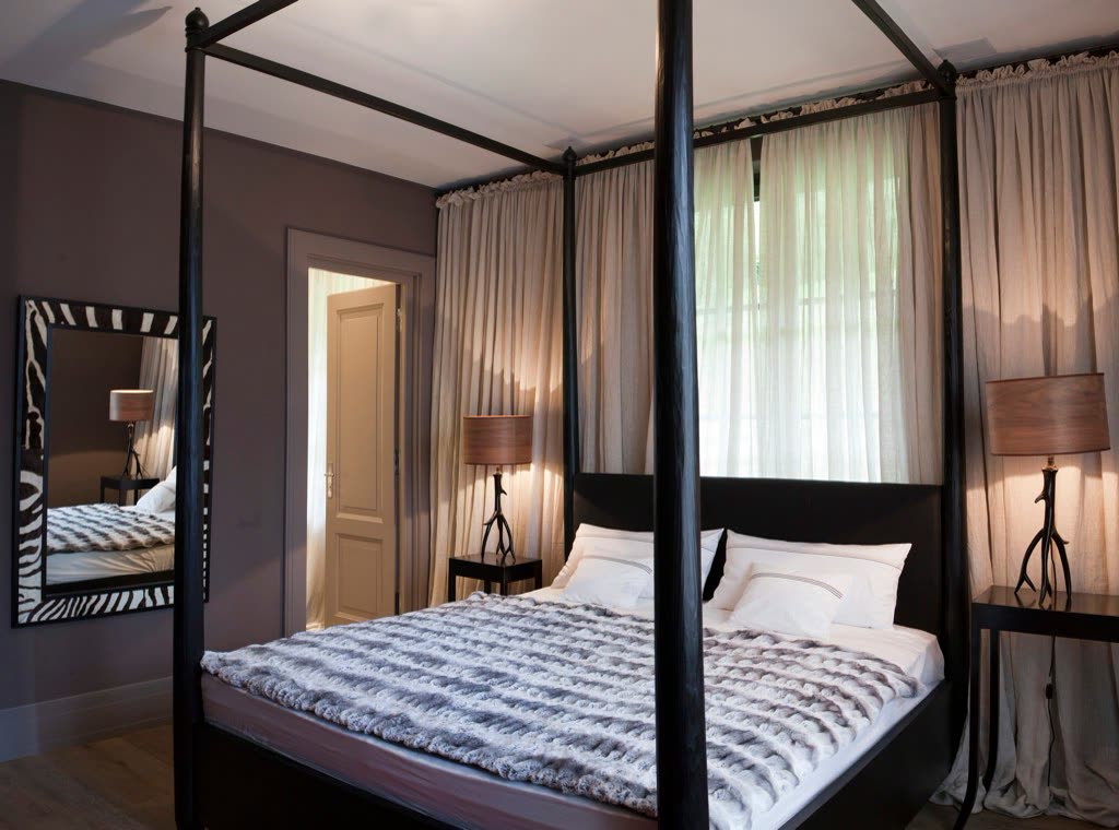 Bedroom with walls in a Farrow & Ball colour and a four-poster bed