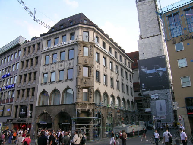 Town-centre commercial building with historic facade and scaffolding on the ground floor