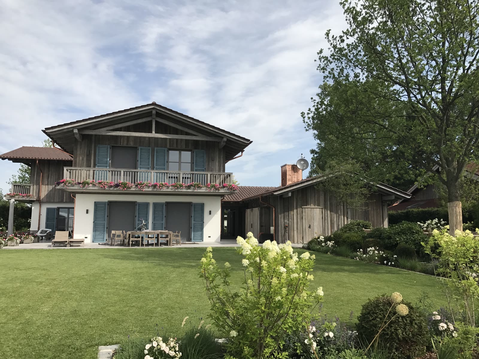 Country house with a timber facade and blue shutters