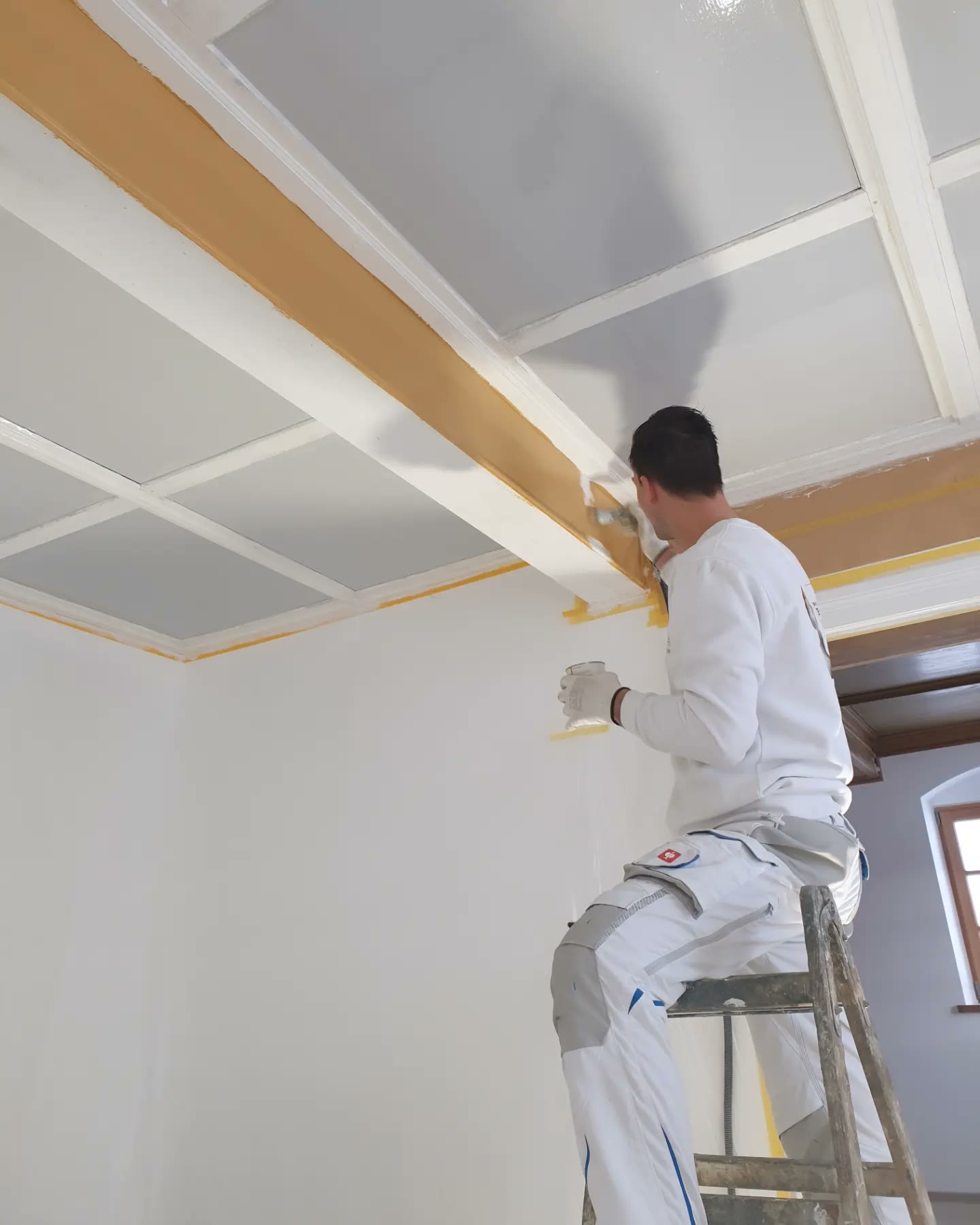 Hierat painter painting a coffered ceiling with a brush